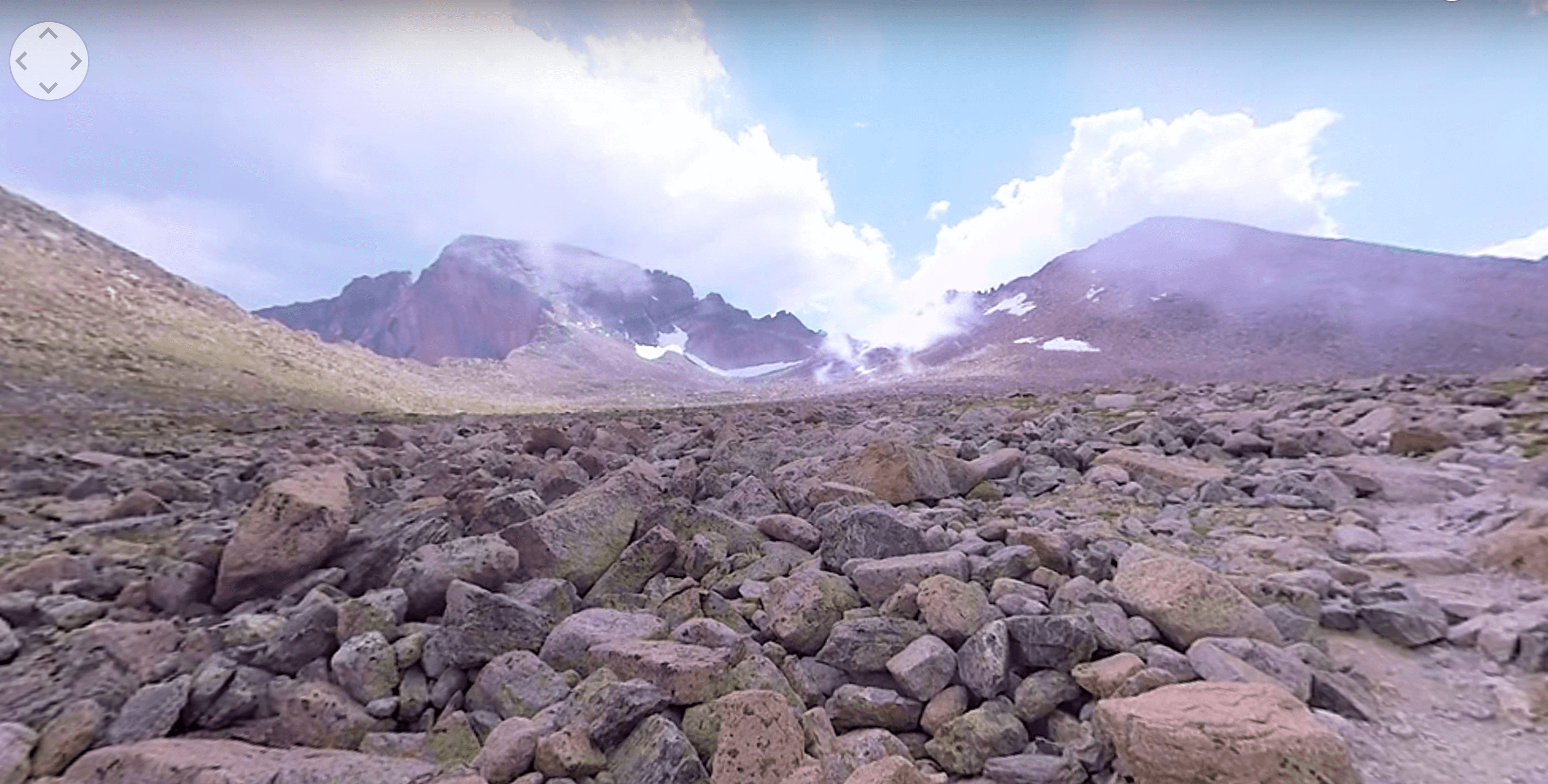 A rocky landscape with mountains and clouds