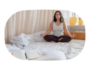 Woman meditating in bed