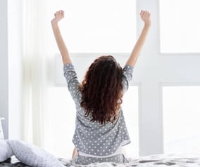 Woman Waking Up From Restful Sleep