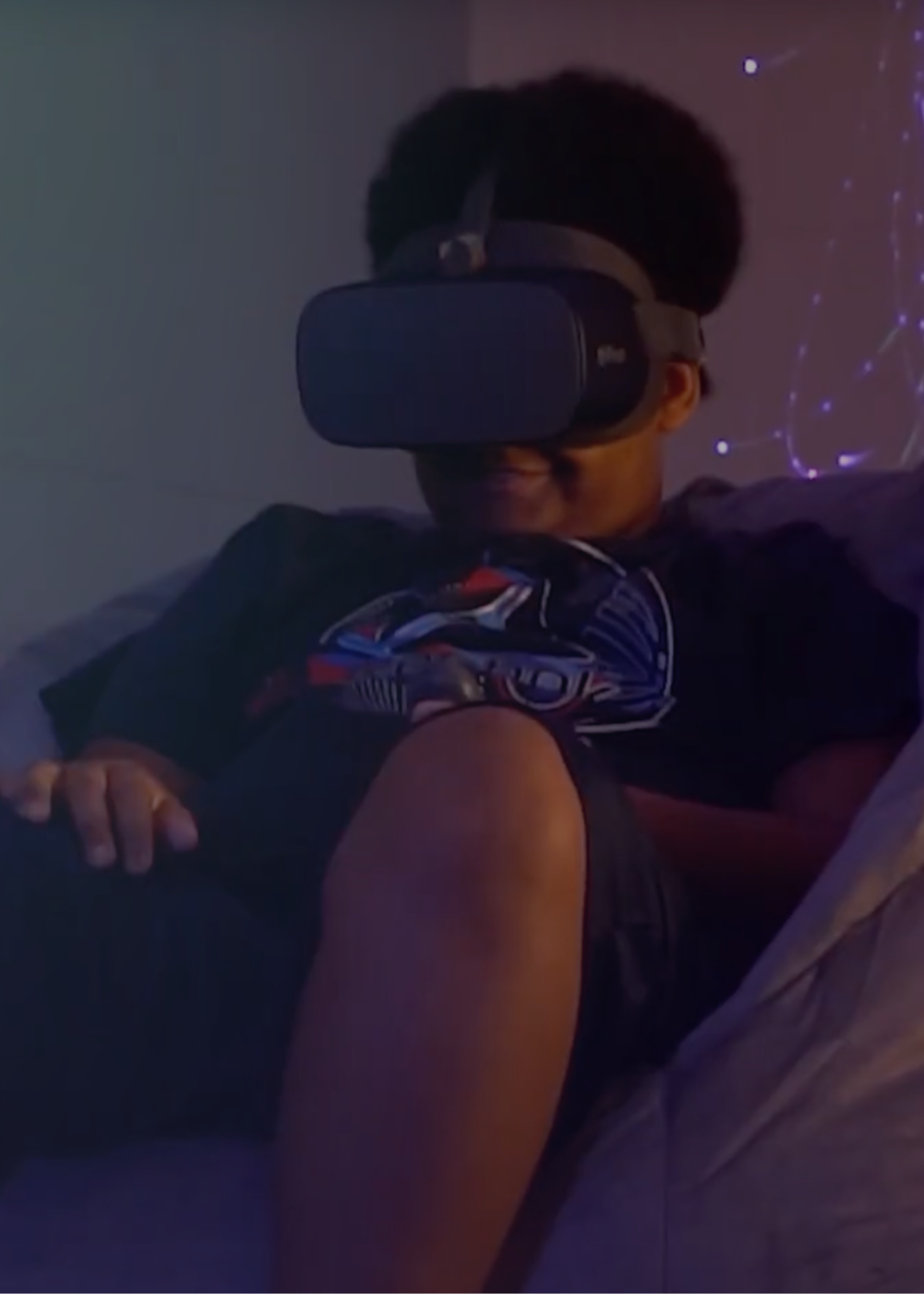 Justice sitting in a bean bag on the floor with VR headset on during a Healium session.