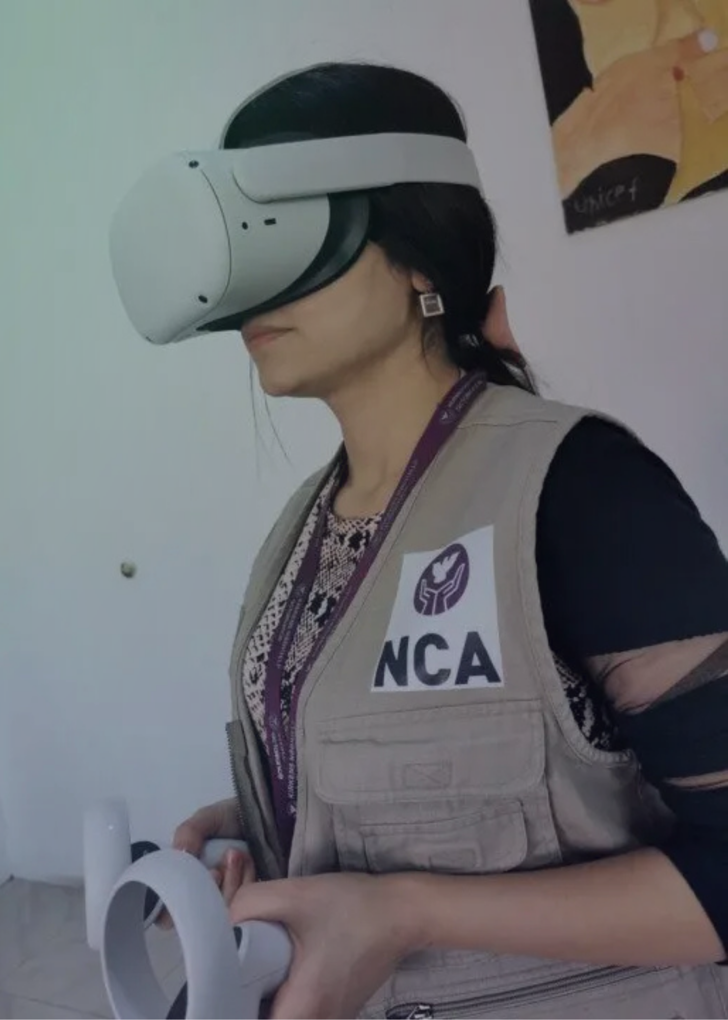Women wearing tan NCA vest and VR goggles while holding controllers.