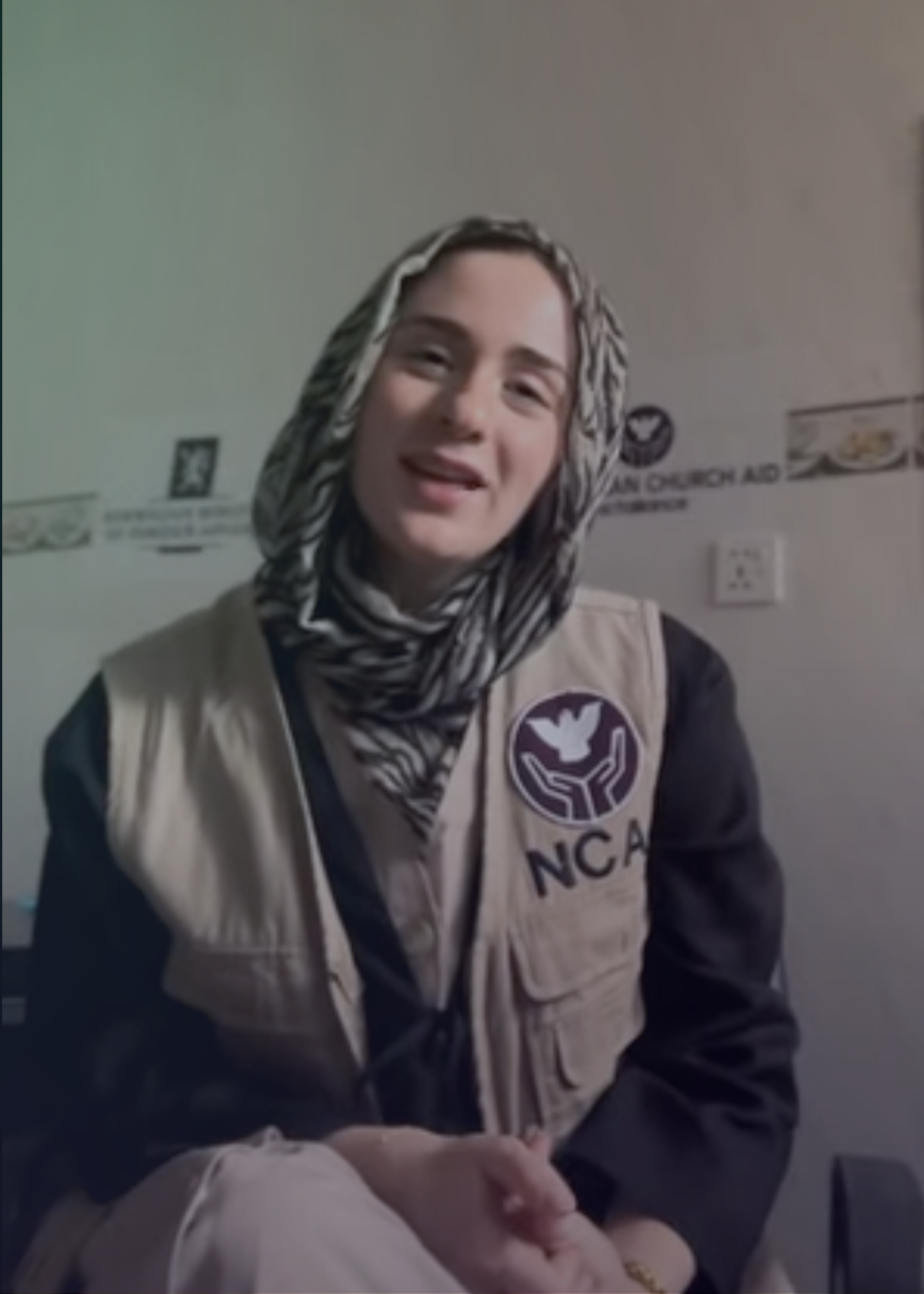 Huda smiles towards the camera wearing an NCA vest.